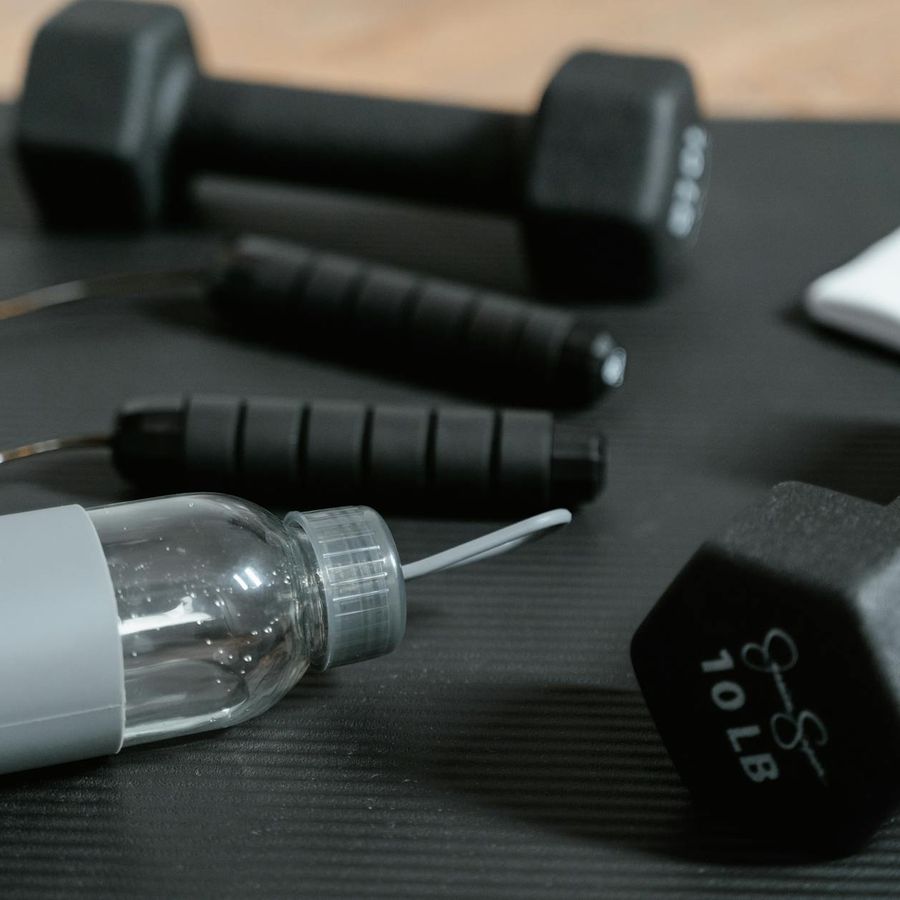 Detailed close-up of gym equipment and workout plan on a table